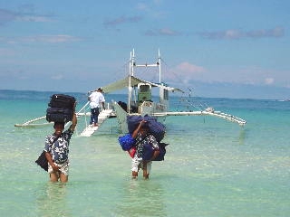 Hotel staffs carry baggages.